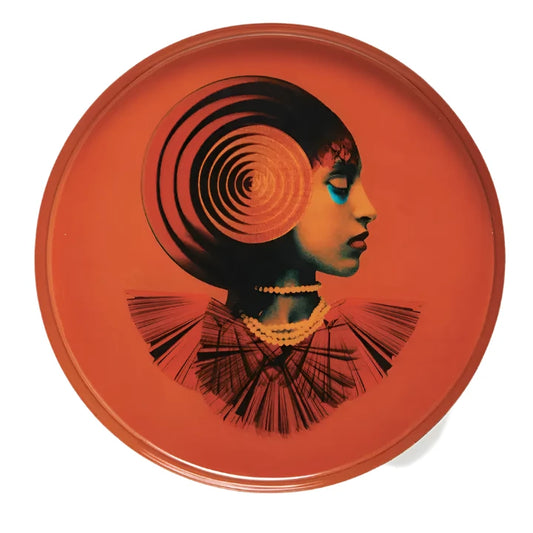 round metal tray in orange with depiction of gypsy figure