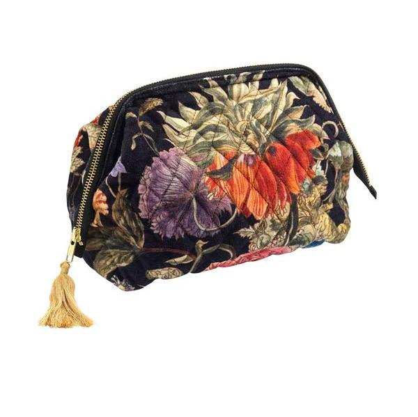 a velvet cosmetic bag with botanical print on black background