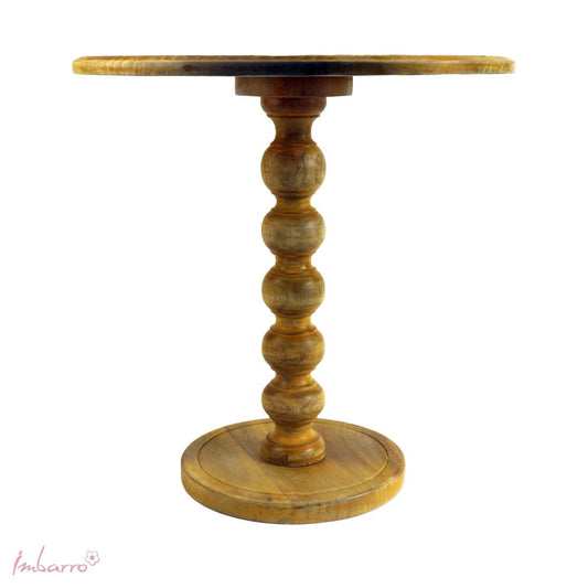 A Moroccan style side table with a carved 45cm diameter top in a distressed yellow.